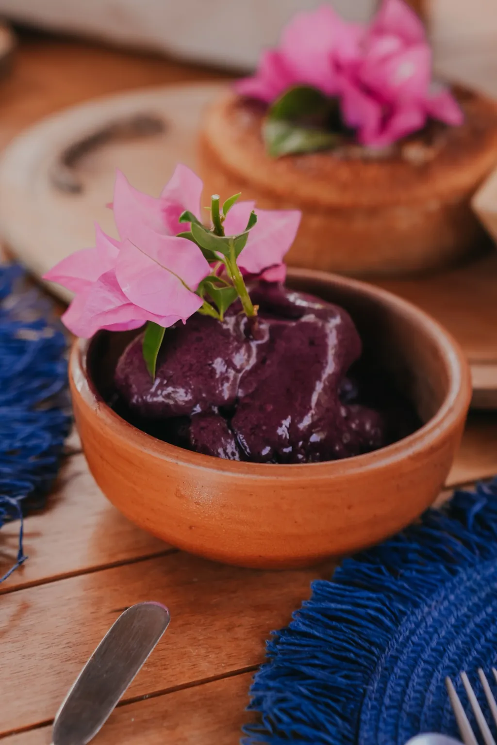 Café da manhã regional: açaí em tigela de barro com flor de buganvília